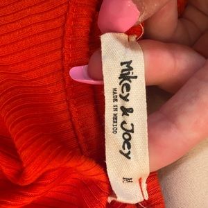 Orange-red body suit